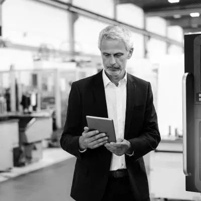 Manager using digital tablet in high tech company Manager using digital tablet in high tech company